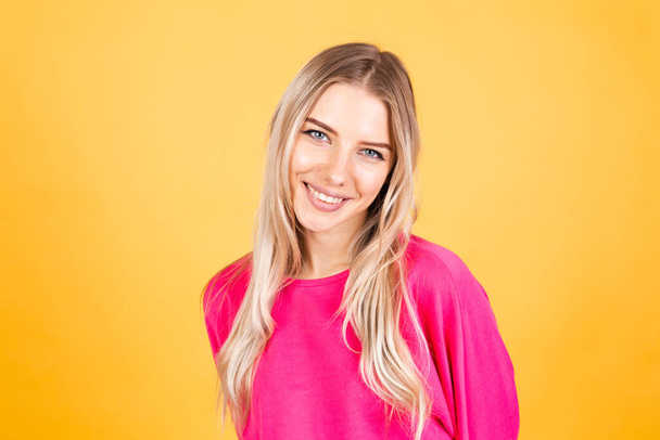Mujer bastante europea en blusa rosa sobre fondo amarillo emociones positivas sonriendo feliz alegre - Foto, Imagen