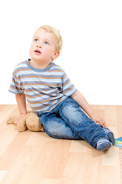 Cute little boy sitting with teddy bear and book isolated - 写真・画像