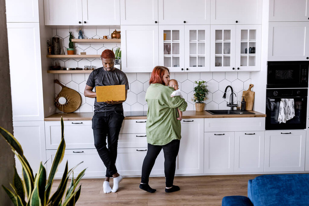 young couple in kitchen, man and woman in the room - Foto, Bild