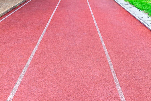 Red rubber running track flooring texture and background  - Photo, Image