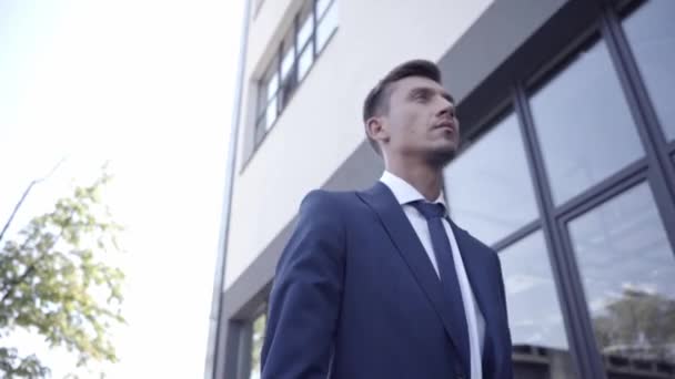 Businessman with laptop walking outdoors  - Кадри, відео