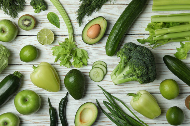 Fresh green vegetables on white wooden background - Фото, зображення