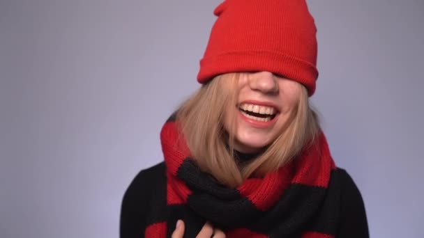 Menina loira atraente rindo em chapéu de gorro vermelho nos olhos - Filmagem, Vídeo