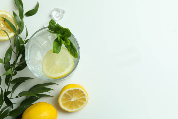 Glass of cocktail with lemon on white background - Photo, Image
