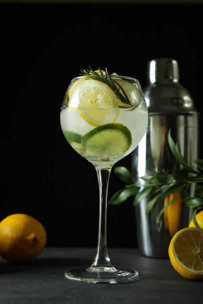 Glass of cocktail with citrus against dark background - Fotoğraf, Görsel