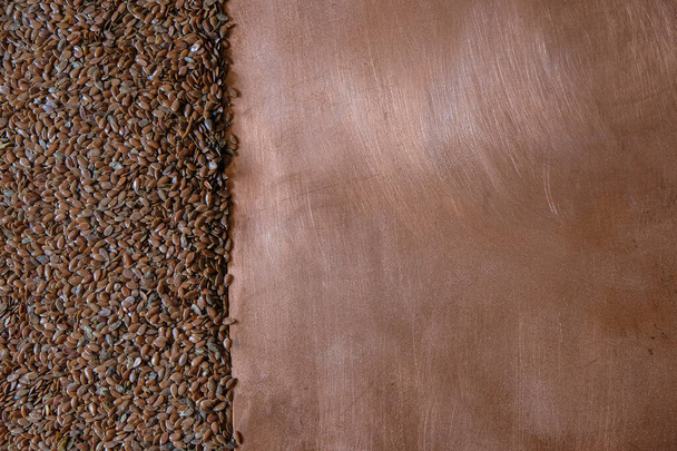 Brown flax seeds on a copper background. Copy space. - Photo, Image