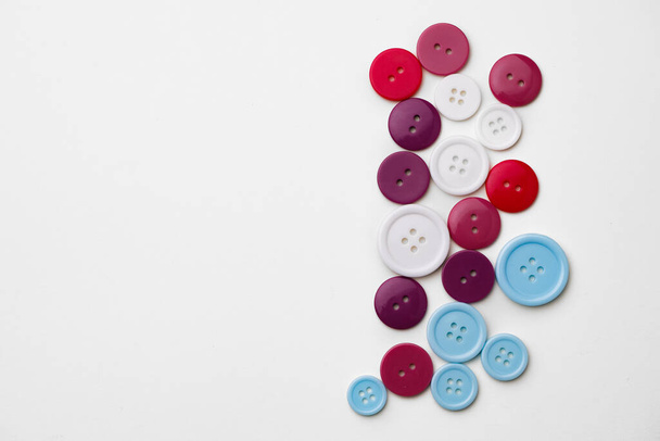 Assortment of colorful buttons on white background - Valokuva, kuva