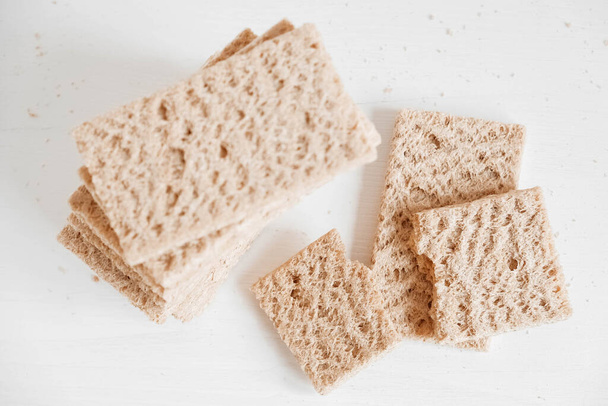 Rye crisp bread on a white wooden background. Top view. Copy, empty space for text. - Photo, Image