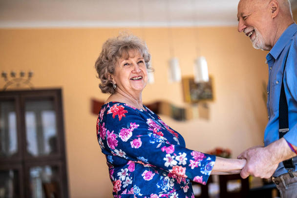 Happy senior couple dancing together at home - Foto, immagini