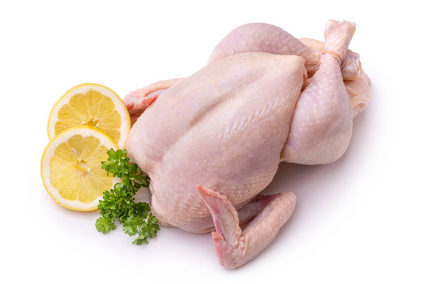 Raw chicken, lemon wedges and a bunch of parsley. Isolate on white background  - Zdjęcie, obraz