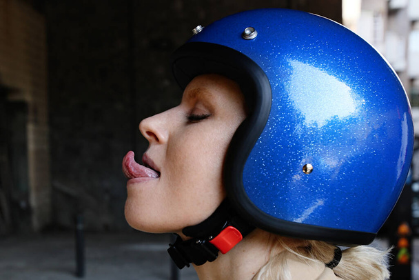 Close-up of young woman posing with blue retro helmet. Outdoor. - Φωτογραφία, εικόνα