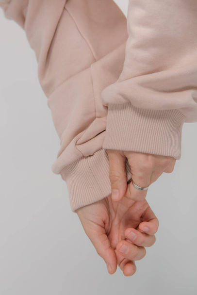 sweatshirt long sleeves female hands close up elastic bands - Фото, зображення