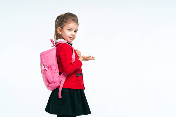 Adorable little girl in red school jacket, black dress, on to th - Photo, Image
