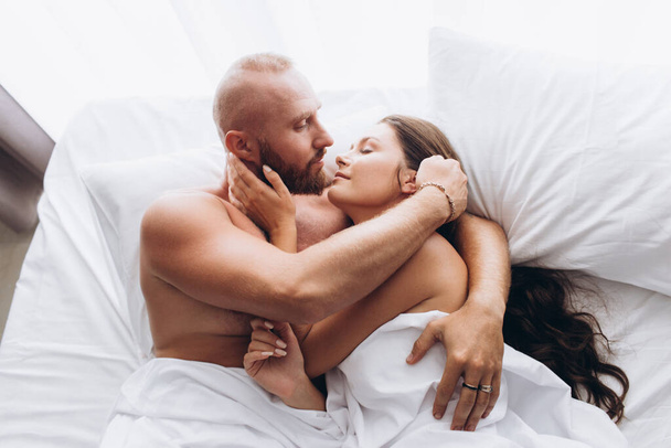 Couple is cuddling in bed. Traditional relationship. - Fotó, kép