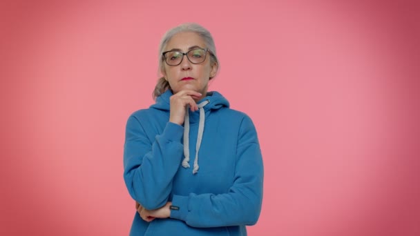 Ragionevole intelligente anziana donna anziana nonna strofinando il mento meditando una soluzione, dubbio domanda - Filmati, video