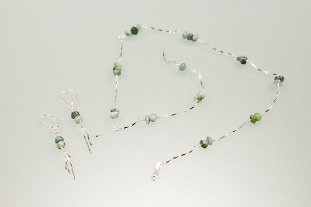 Silver earrings and necklace with emerald gemstones - Photo, Image
