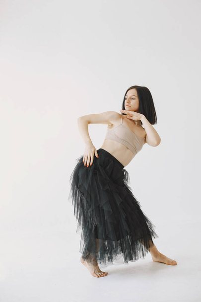 Beautiful young woman dancing in studio - Fotoğraf, Görsel