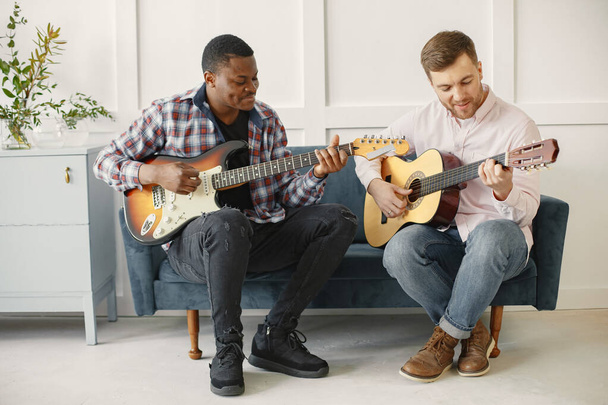 African man and Caucasian man playing guitar - Foto, Imagem