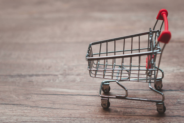 Empty shopping cart on wooden copy space - Photo, Image