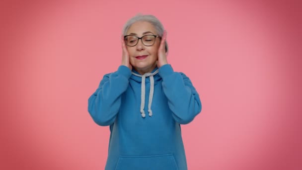 Wil niet horen en luisteren, geïrriteerde oudere vrouw bedekken oren, gebaren nee, vermijden van advies - Video