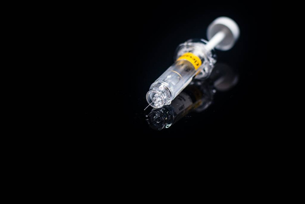 Injection, vaccine on a black background - Foto, imagen