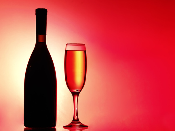 Glass of champagnes on light yellow-red gradient background. Abstract background - Photo, Image