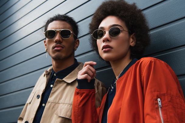 young african american man posing with curly woman in sunglasses outside  - Photo, Image