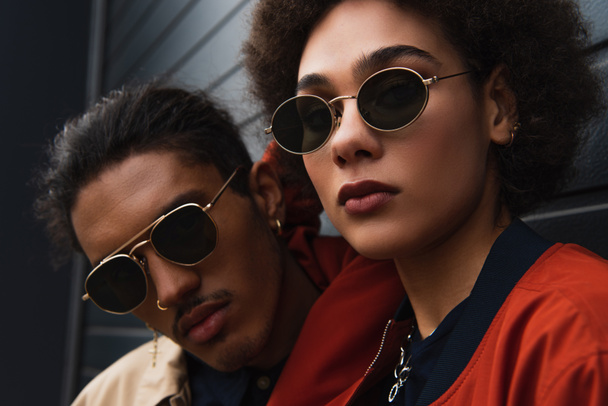 close up of young african american man posing with stylish woman in sunglasses outside  - Zdjęcie, obraz