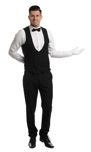 Handsome butler in elegant uniform on white background - Foto, afbeelding