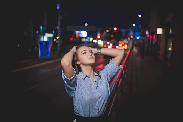 A beautiful Bosnian Caucasian woman posing in the street during night time - Foto, Bild