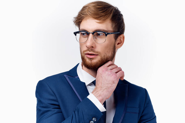 business man in white shirt straightens his jacket and bushy beard model light background - Photo, image