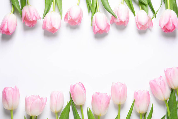 Beautiful pink spring tulips on white background, top view. Space for text - Fotografie, Obrázek