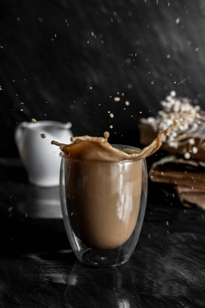 Splashin Latte coffee on the dark background - Photo, Image