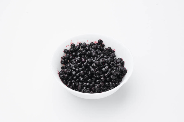 Bilberry on white plate isolated on white background. Top view. Free space for your text. Mockup  - Foto, immagini