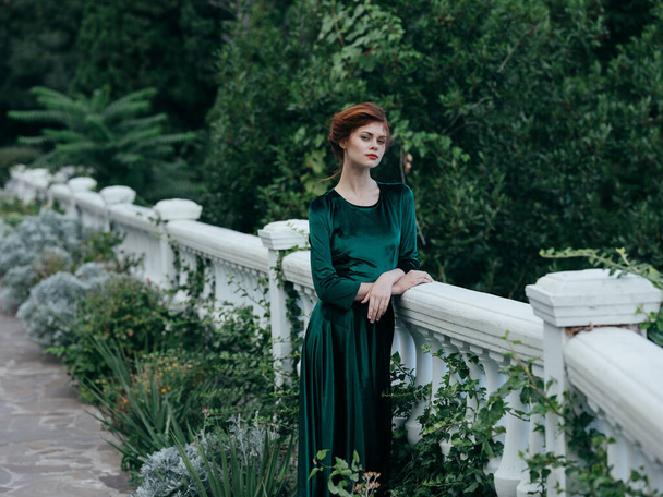 mujer en vestido verde posando en la naturaleza  - Foto, imagen