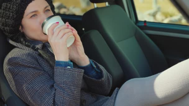 Nainen ottaa pois kuppi istuu autossa - Materiaali, video