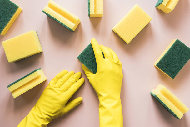 close up person with yellow gloves sponges. Resolution and high quality beautiful photo - Valokuva, kuva