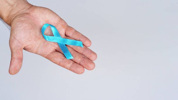 close up hand holding blue ribbon. Resolution and high quality beautiful photo - Zdjęcie, obraz
