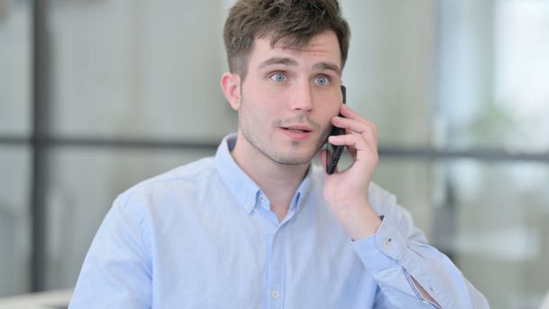 Portrait of Young Man Talking on Phone - Фото, зображення