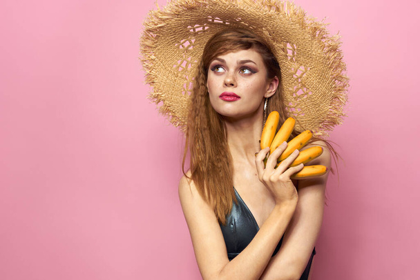 Woman in beach straw hat bananas holding fruits Exotic swimsuit pink background - Foto, immagini