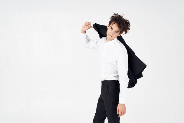 business guy curly hair jacket in hands fashion posing - Valokuva, kuva