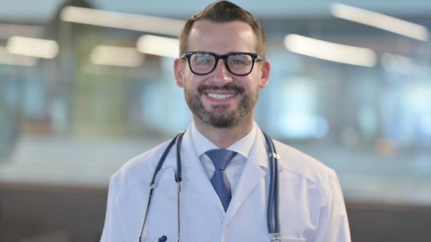 Portrait of Young Male Doctor Smiling at Camera  - Foto, Imagen