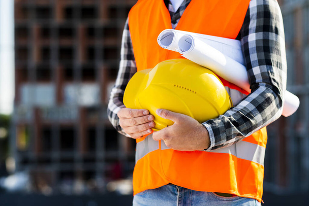 close up construction engineer holding helmet. Resolution and high quality beautiful photo - Fotoğraf, Görsel