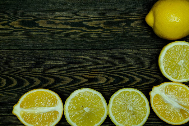 Ripe source lemons  on a wooden background  photographed from above in the form of a frame - Photo, Image