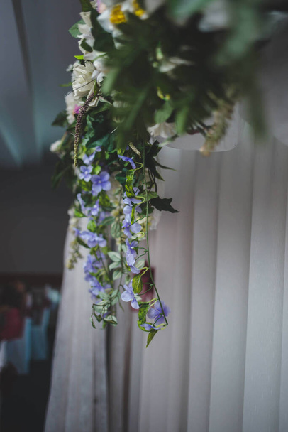 A vertical shot of a beautiful floral arrangement on a buffet table - Foto, Imagen