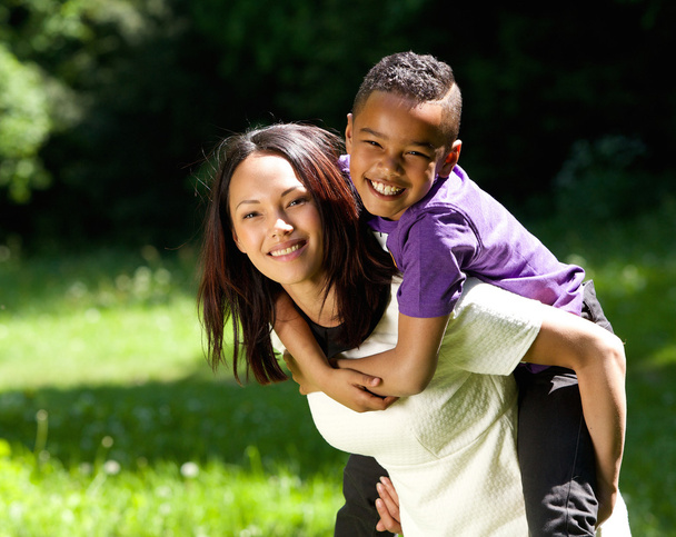 Mother and son smiling together outdoors - Photo, Image