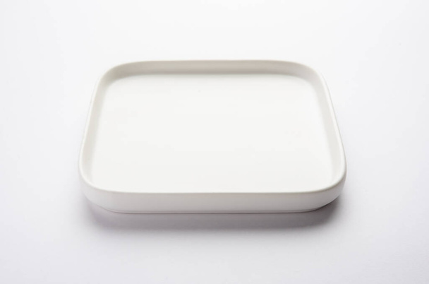 Empty white ceramic square plate isolated on white background - Photo, image