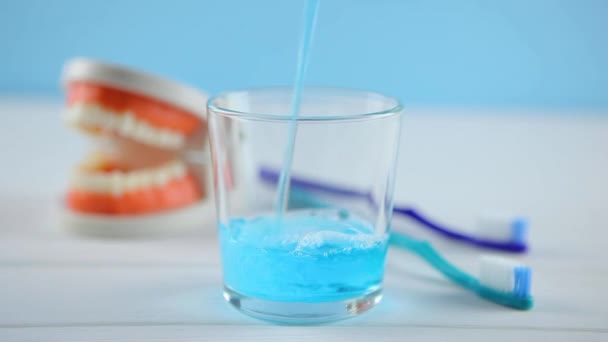 mouthwash on the table in a glass. Oral care - Footage, Video
