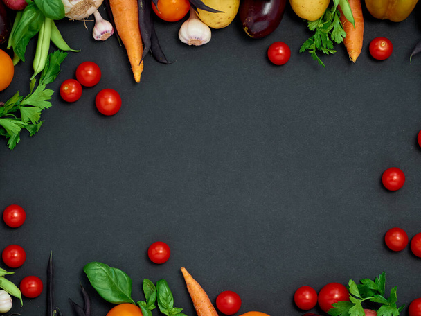 Frame of various  vegetables on dark background, top view. - Photo, Image