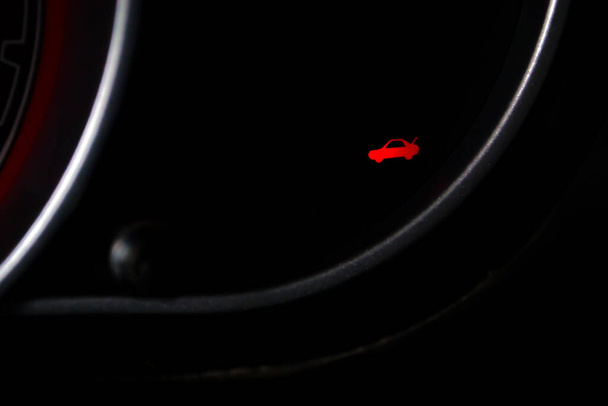 Sensoren im Armaturenbrett des Autos signalisieren, dass man vergessen hat, den Kofferraum zu schließen. Fahrer, sei vorsichtig. - Foto, Bild